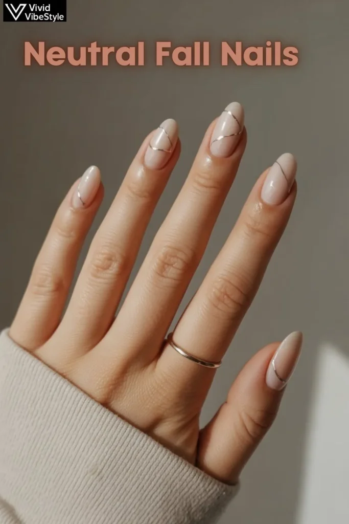 Beige neutral fall nails with minimalist metallic line nail art, perfect for beginners