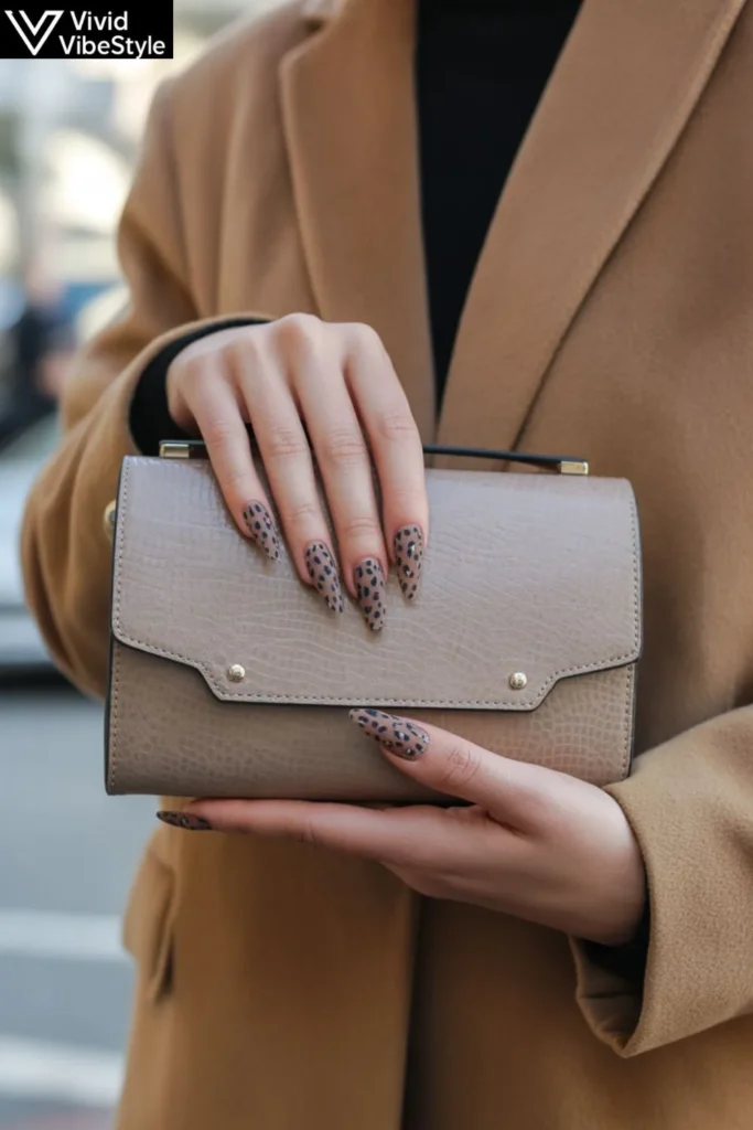 Neutral leopard print nails styled with camel coat and neutral handbag