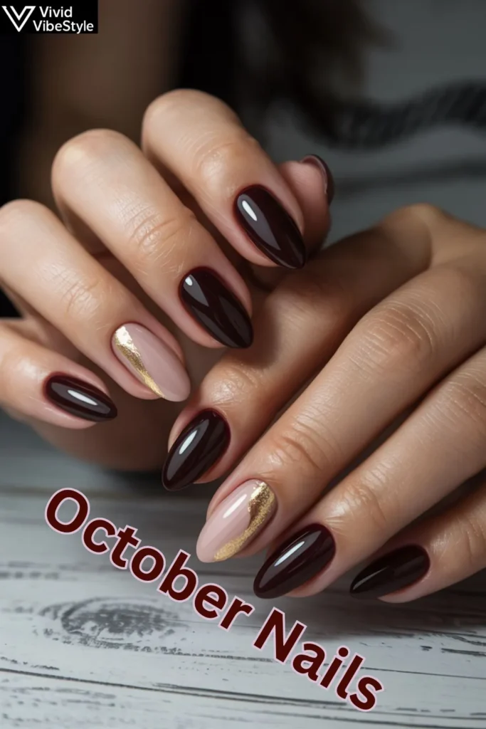 Professional October nails with deep wine polish and gold foil accents for an elegant fall manicure.