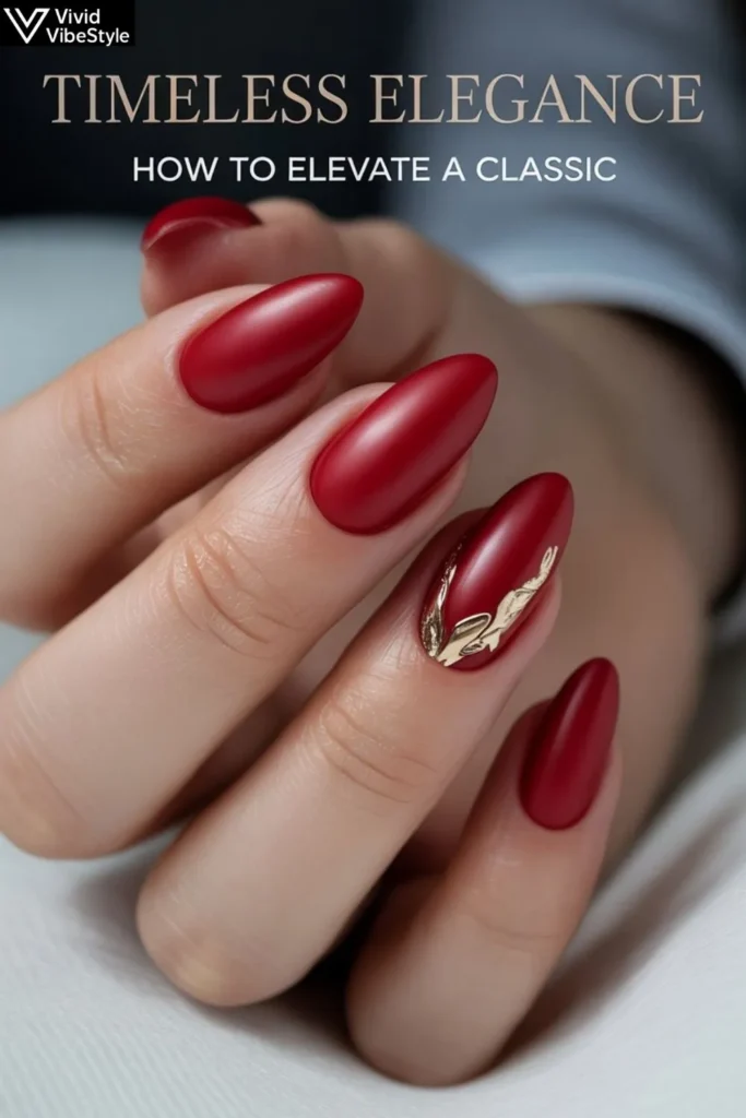 Classic matte red almond Christmas nails with a gold foil accent design