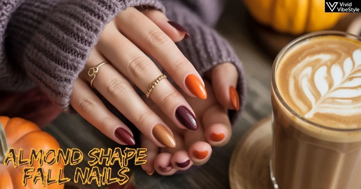 Medium-length almond shape fall nails in burnt orange and burgundy with cozy autumn sweater and latte