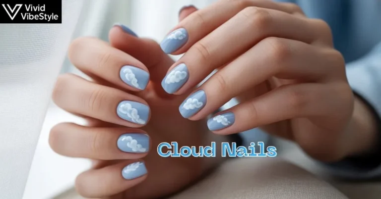 Close-up of trendy 2025 cloud nails with soft blue base and fluffy white clouds in natural light