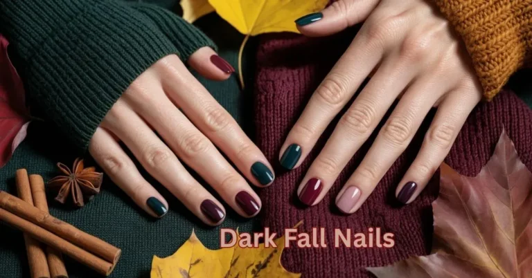 Hands with dark fall nail designs in rich autumn shades like burgundy and forest green, surrounded by seasonal elements.