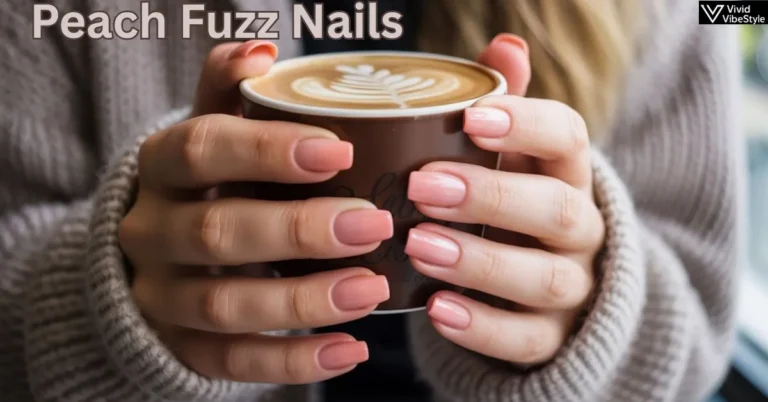 Close-up of hands with Peach Fuzz Nails holding a coffee cup, showcasing Pantone’s 2025 Color of the Year manicure trend