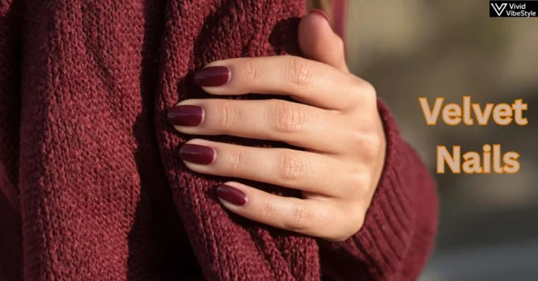 Burgundy velvet nails paired with a cozy cashmere sweater, showcasing fall’s most luxurious nail trend in soft autumn lighting.